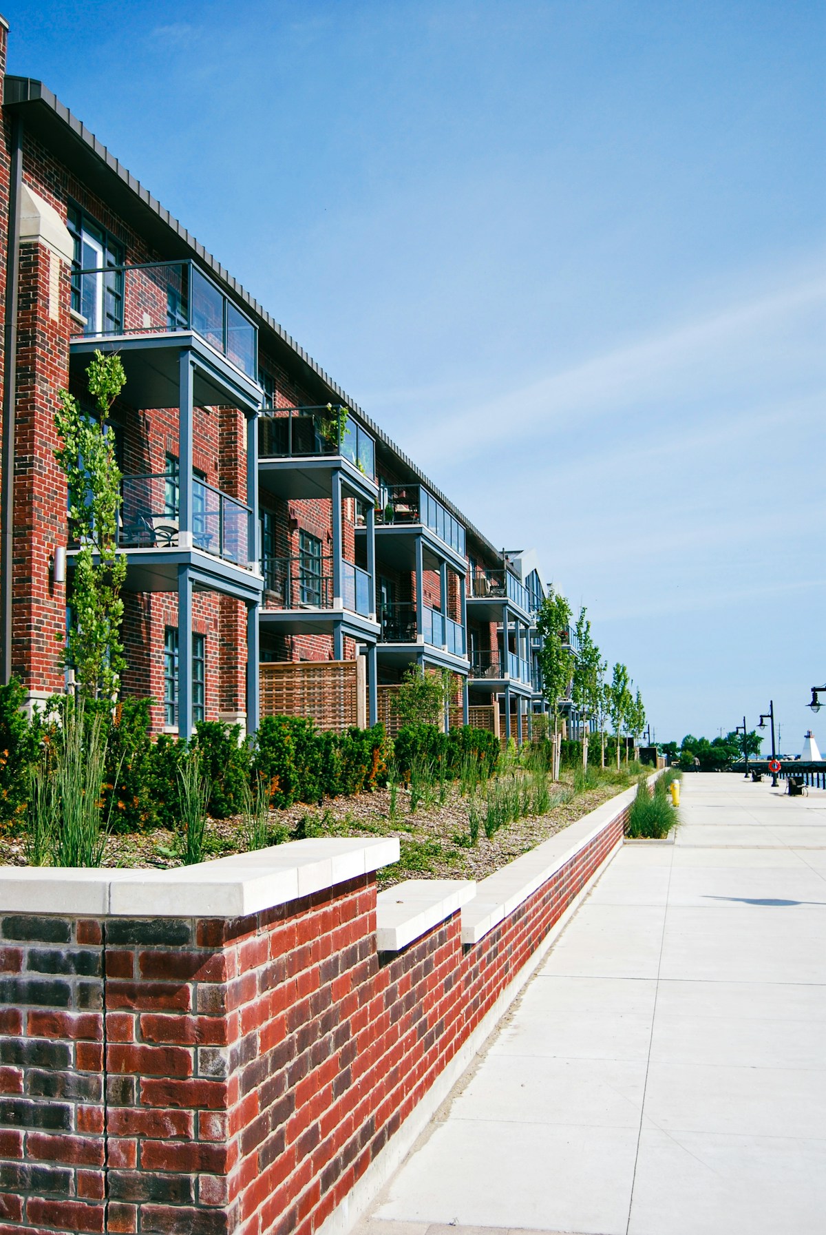 A modern red brick apartment complex with balconies