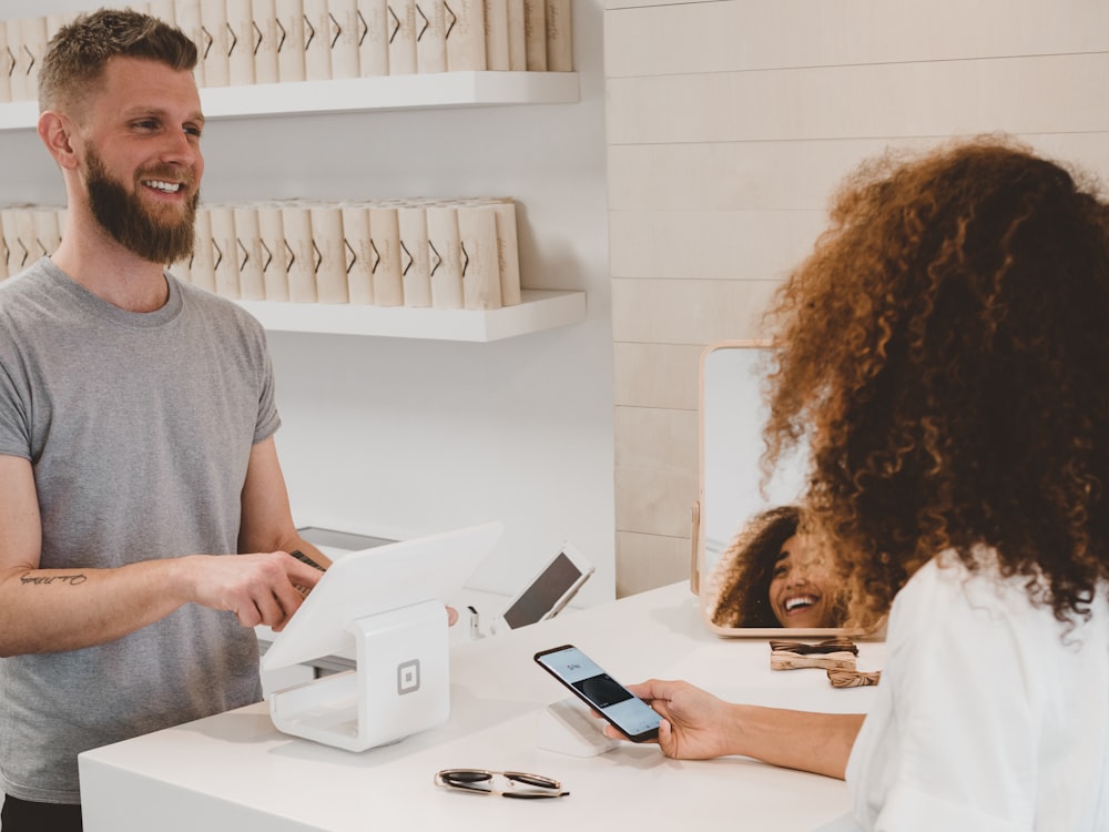 A customer paying contactlessly with a mobile phone at a card terminal
